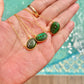 Malachite evil eye necklace featuring a green and black eye-shaped charm on a dainty gold chain
